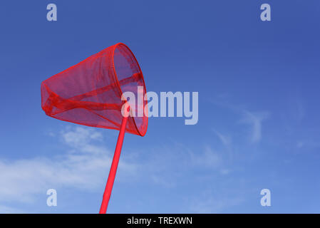 Summer background with bright object. Red butterfly net for catching butterflies or fish. Children's fun Stock Photo