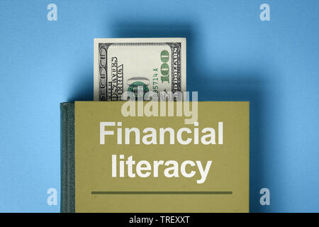 The concept of financial literacy. A book with knowledge about money and investments. Bookmark from the dollar bill Stock Photo