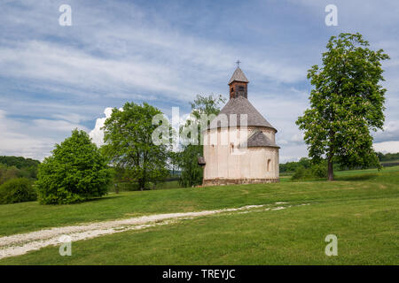 Saint Nicholas and Virgin Mary rotunda, Selo, Slovenia. Oldest rotunda in Slovenia - build in 13th century. Building of church standing near dirt road Stock Photo