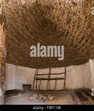 Interior with thatched roof ceiling inside a recreated Neolithic stone age hut / stoneage huts. Exhibition; Visitor centre Stonehenge / Stone Henge.  UK (109) Stock Photo