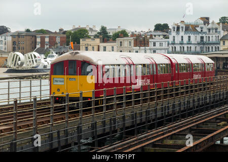 Train (former London underground train and carriages) on Ryde pier in Island Line livery, a railway line on the Isle of Wight, running 8 1⁄2 miles (13.7 km) from Ryde Pier Head to Shanklin. UK. (99) Stock Photo