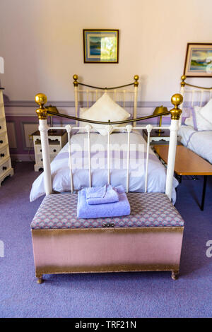 Old Fashioned Metal Single Bedstead In An Bedroom Decorated