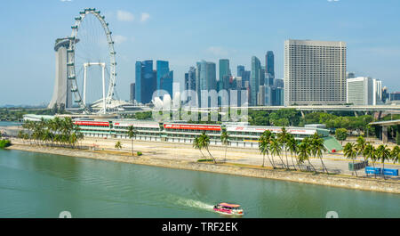 Marina Bay Sands, Singapore Flyer Ferris Wheel and motorsport Grand Prix GP pit stop facilities at Marina Bay and Singapore skyline in background.. Stock Photo
