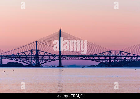 Sunrise with the three Forth Bridges at South Queensferry Stock Photo