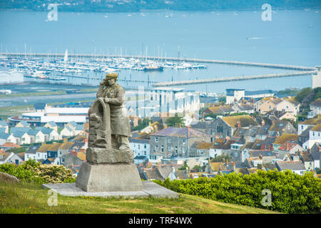 The Spirit of Portland stone sculpture at Portland Heights with Fortuneswell  village and harbour below. Dorset, England, UK. Stock Photo