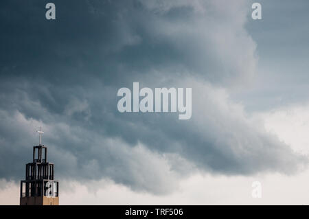 Dramatic dark clouds above a church tower in Budapest Stock Photo