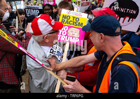 London, UK. 4th June 2019. Front liners of the Trump Protest march forcefully knocking over an elderly bystander to the floor whilst a heated exchange of words were had. In Parliament Square, London, U.K. Credit: Yousef Al Nasser/Alamy Live News Stock Photo