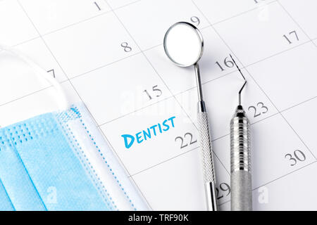 Dentist appointment in calendar and professional dental tools. Stock Photo