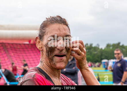 Warrington, UK. 2nd June 2019. Race for Life 2019, Warrington, in aid of Cancer Research. Runners get soaked with muddy water at the mud pit Stock Photo