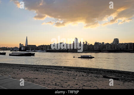 View of the Shard, riverside homes, barges on River Thames and City of London cityscape from Rotherhithe South London UK  KATHY DEWITT Stock Photo