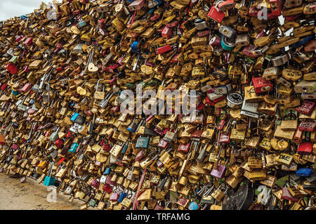 Padlocks fastened to each other on bridge balustrade at Seine River in Paris. One of the most impressive world’s cultural center in France. Stock Photo