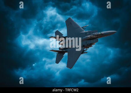 F-15 Strike Eagle. A composite image of a USAF F-15 flying through stormy skies. Stock Photo