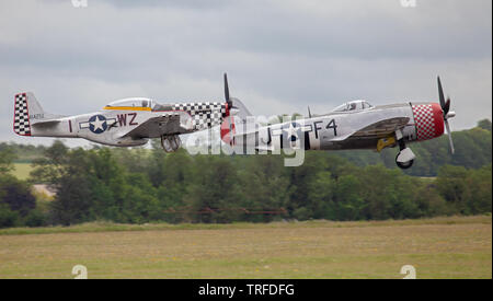 Republic P-47D Thunderbolt F4-J and North American P-51D Mustang WZ-1 taking off from Duxford Aerodrome Stock Photo