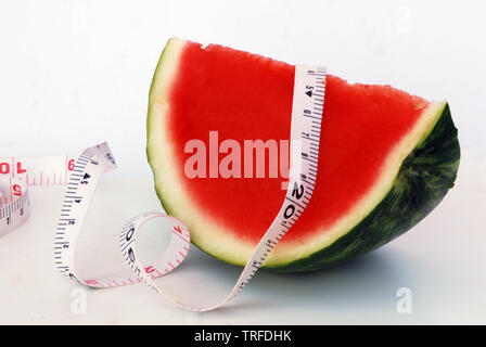 A piece of watermelon with measuring tape Stock Photo