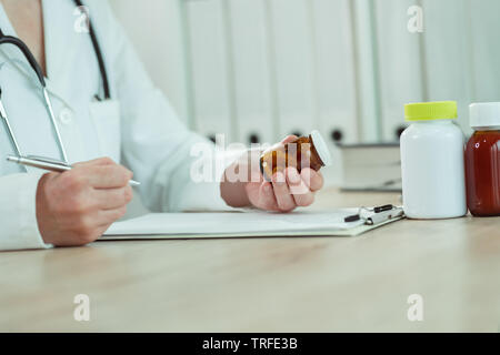 Doctor writing generic drugs prescription in medical office Stock Photo