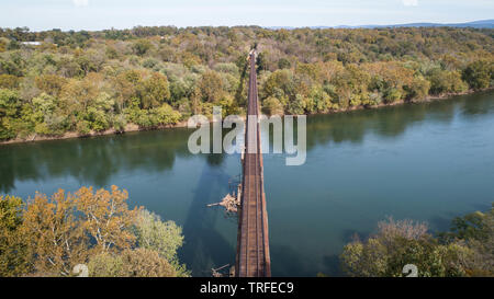 Scenic Daytime Aerial Landscape Photograph Looking Down Rusty Old Vintage Antique Steel Train Track Crossing Historic Potomac River in Maryland, USA Stock Photo