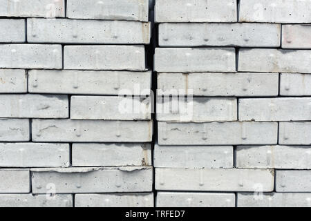 Stacked concrete bricks, gray cement piled construction material Stock Photo