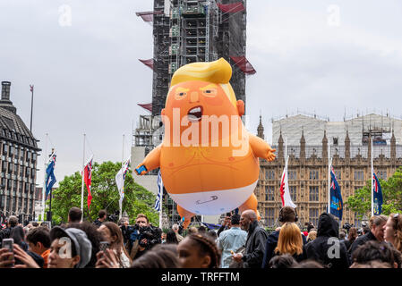Donald Trump baby blimp balloon in Parliament Square, London, UK during US President State Visit. Flying above people in front of Parliament, UK Stock Photo