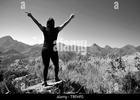 midle age woman on the top of a montain. Concept of success, freedom, joy, self estime, adventure