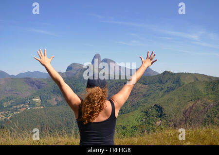 midle age woman on the top of a montain. Concept of success, freedom, joy, self estime, adventure Stock Photo