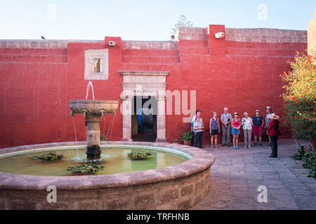 Guided tour visiting a beautiful courtyard at Monastery of Santa Catalina de Siena also known as Convent of Santa Catalina in Arequipa, Peru Stock Photo
