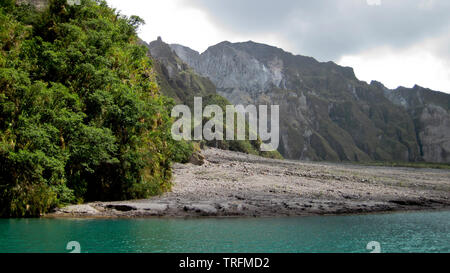 The shoreline of the lake to view the deepest lake in the Philippines at eyelevel, one is engulfed in the grand crater of the volcano. Stock Photo