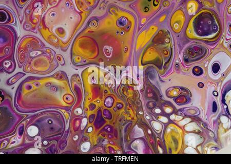Background of a closeup on a psychedelic abstract acrylic pour painting that is done in bright yellow, magenta, dark purple, white, and black. Stock Photo