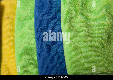 Green, yellow, and blue colored cloths shown close up Stock Photo