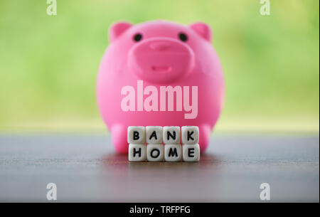 Housing industry mortgage plan and residential tax saving strategy / Real estate sale home savings loans market concept Pink piggy bank and dices word Stock Photo