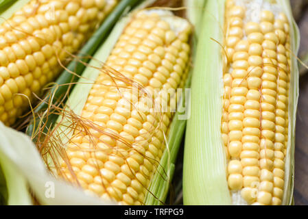 Corn on cobs and sweet corn ears on background close up Stock Photo