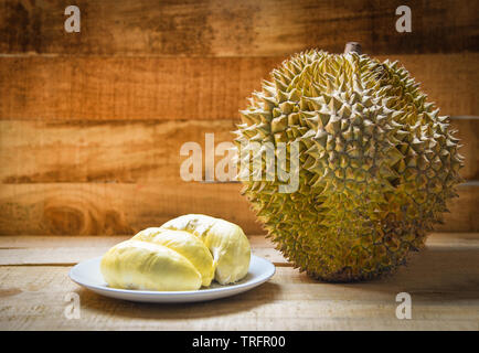 Durian riped on plate and durian fruit on wooden background on summer Stock Photo