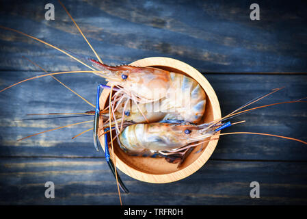 Fresh shrimps raw on bowl with dark wooden background Stock Photo