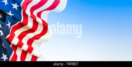 USA flag background. Close-up of American flag on the left side, blue and white colored space for text on the right side of the image. Stock Photo