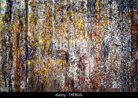 Colorful torn posters on grunge old wall background Stock Photo