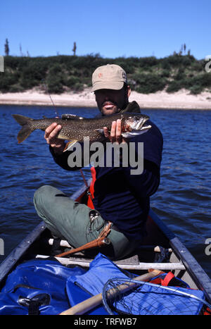 The Norwegian Asbjørn Sandbæk with a lake trout, Salvelinus namaycush, caught on a canoe trip on the Thelon River in the Northwest Territories, Canada. August, 2001. Stock Photo