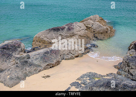 Images of rocks with waves crashing on a beach at St Ives in Cornwall UK Stock Photo