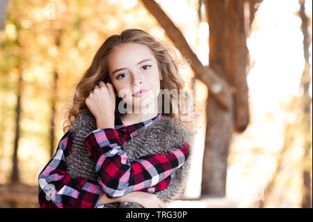 Beautiful blonde girl 14-15 year old posing over nature background. Looking at camera. Stock Photo