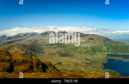 Ireland Autumn landscape view to Carrauntoohil and the Macgillycuddy's Reeks in clouds as seen from Torc Mountain summit in County Kerry, Ireland