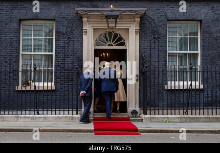 President Donald Trump and his wife Melania stand on the steps of number 10 with Prime Minister Theresa May and her husband Philip on Downing Street,