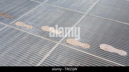 Stylized traces on the metal lattice as background Stock Photo