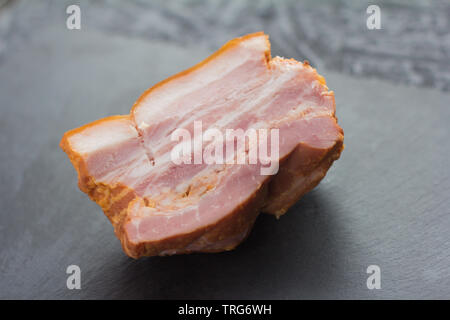 smoked bacon, homemade smoked pork brisket on dark background Stock Photo