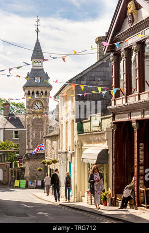 Lion Street, Hay-On-Wye, with bunting on a sunny day during the book festival. Included are Richard Booth's bookshop and the Victorian clock tower. Stock Photo