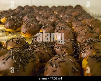 profiterol covered in chocolate and dragee Stock Photo