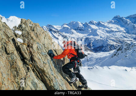 Perfect equiped alpinist climbing in high alpine region in Monte Rosa mountains Stock Photo