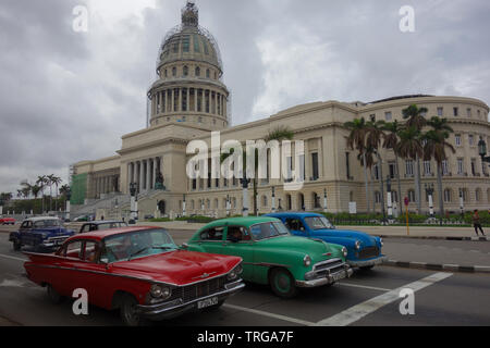 Havana, Cuba - 29th January 2018: Four different classic American cars waiting in front of the traffic lights next to the El Capitolio Stock Photo