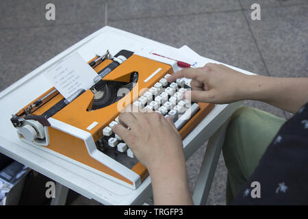 Young man working on old vintage manual typewriter Stock Photo