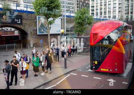 A queue of bus passengers wait for the next service at Waterloo Station during the morning rush-hour, on 5th June 2019, in London, England. Stock Photo