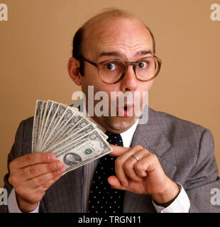 a man in underwear is holding money Stock Photo - Alamy