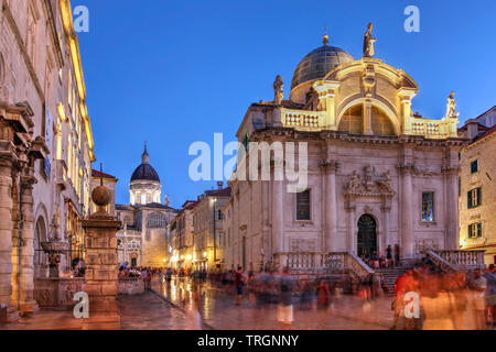Street scene with Church of Saint Blaise in Dubrovnik, Croatia at night. Dubrovnik Cathedral's dome visible in the background. Stock Photo