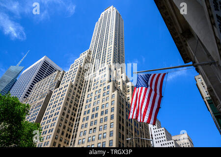 New York, USA,  21 May 2019. A US flag is seen in front of 500 Fifth Avenue, a 60-floor, 697-foot (213 m) tall skyscraper built in 1931 in midtown New Stock Photo